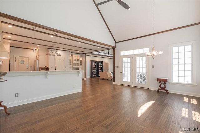 8907 First Branch Ln, Chesterfield, VA 23838 - unfurnished living room featuring ceiling fan, baseboards, dark wood-type flooring, high vaulted ceiling, and a chandelier