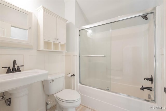 8907 First Branch Ln, Chesterfield, VA 23838 - full bathroom featuring toilet, shower / bath combination with glass door, a decorative wall, and wainscoting