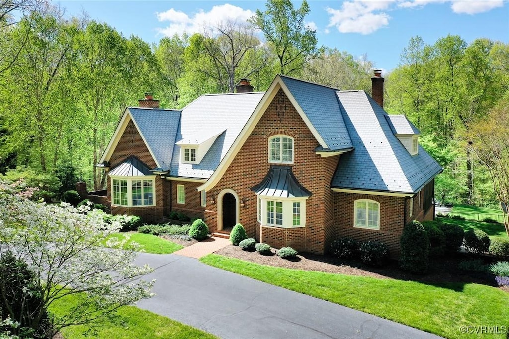 602 Cornwallis Pl, Manakin Sabot, VA 23103 - tudor home with brick siding, a front lawn, and a chimney