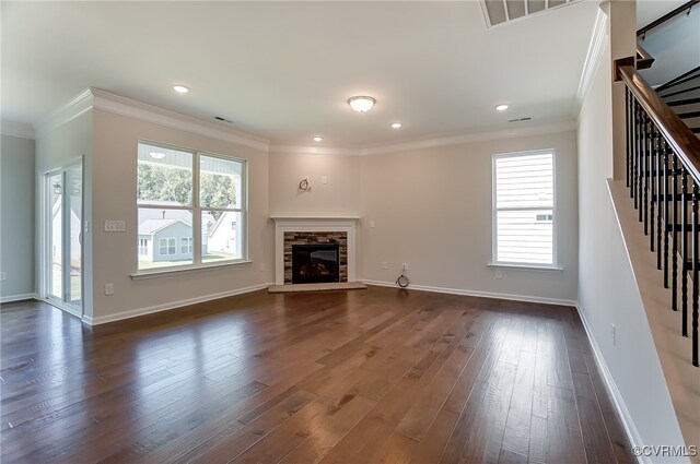 unfurnished living room featuring crown molding, dark wood-style flooring, stairs, and visible vents