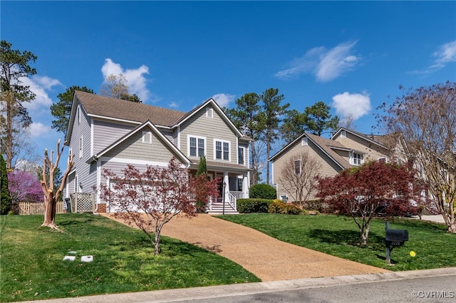 view of front facade with a front yard and concrete driveway