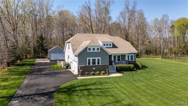 17248 Ivory Bill Ln, Chesterfield, VA 23838 - view of front facade with an outbuilding, a detached garage, a porch, stone siding, and a front lawn