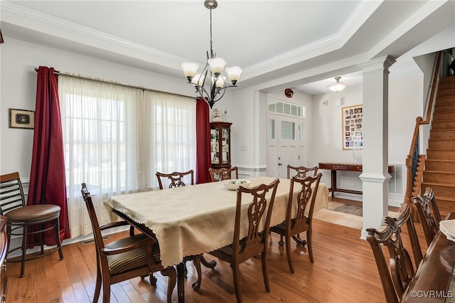 17248 Ivory Bill Ln, Chesterfield, VA 23838 - dining room featuring a tray ceiling, light wood-type flooring, ornate columns, and a notable chandelier