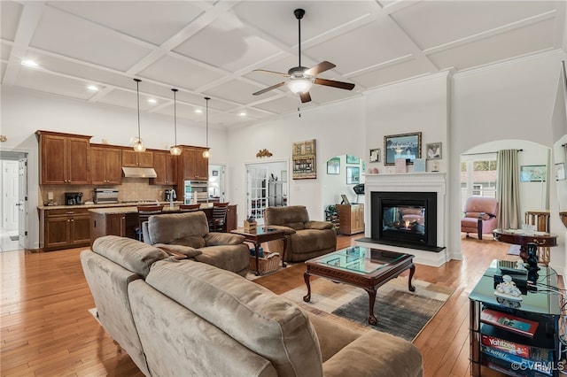17248 Ivory Bill Ln, Chesterfield, VA 23838 - living area featuring a ceiling fan, a glass covered fireplace, a high ceiling, coffered ceiling, and light wood finished floors