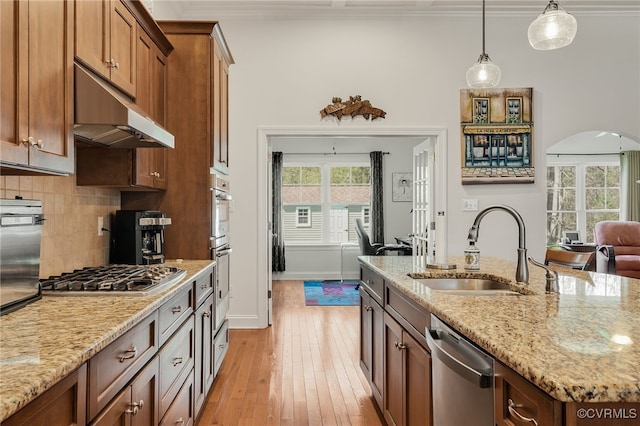 17248 Ivory Bill Ln, Chesterfield, VA 23838 - kitchen with arched walkways, ornamental molding, under cabinet range hood, a sink, and stainless steel appliances