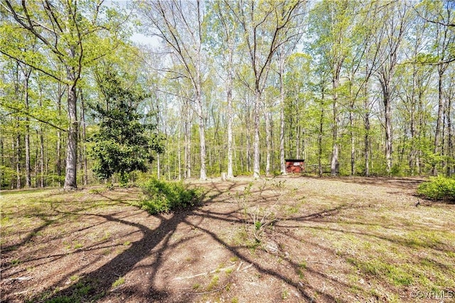 view of yard with a view of trees