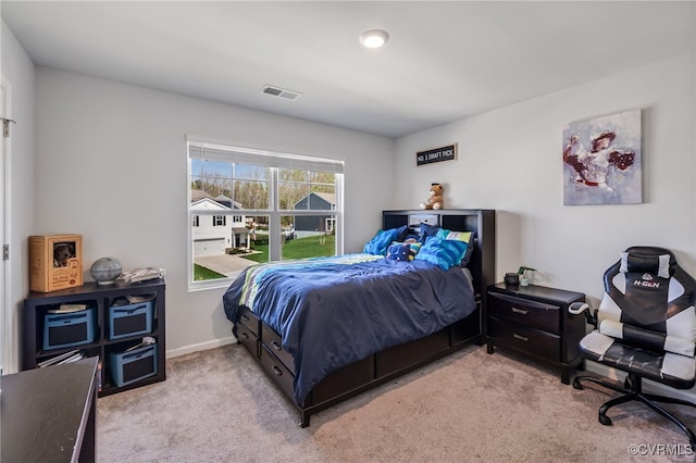 bedroom with light carpet, baseboards, and visible vents