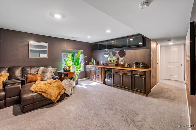 carpeted living room featuring wine cooler, baseboards, recessed lighting, and a bar
