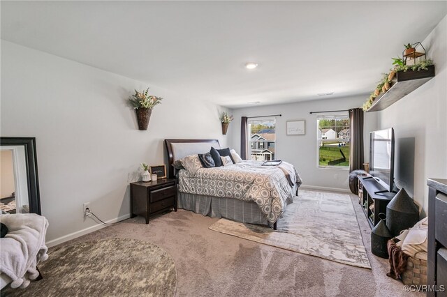 carpeted bedroom featuring baseboards