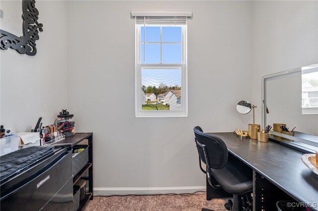 office space with plenty of natural light, baseboards, and carpet flooring
