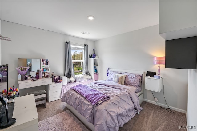 bedroom with carpet, visible vents, and baseboards
