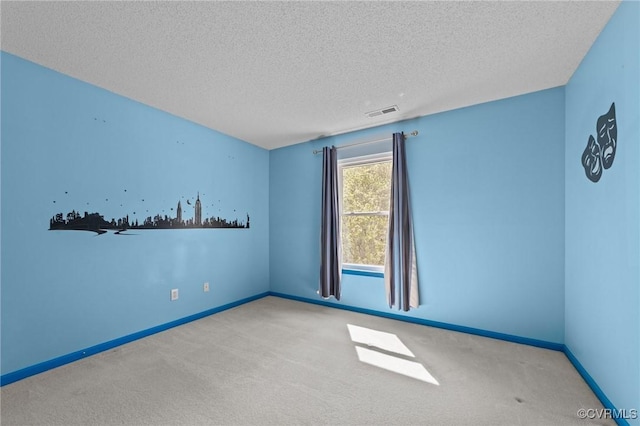 carpeted empty room featuring visible vents, baseboards, and a textured ceiling