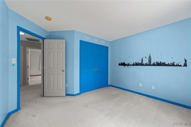 unfurnished bedroom with visible vents, baseboards, a closet, and carpet floors