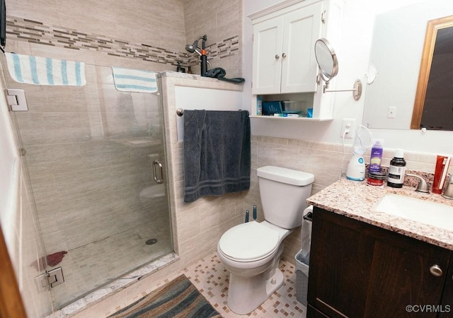 9522 Broad Meadows Rd, Glen Allen, VA 23060 - bathroom featuring tile walls, a shower stall, vanity, toilet, and tile patterned flooring
