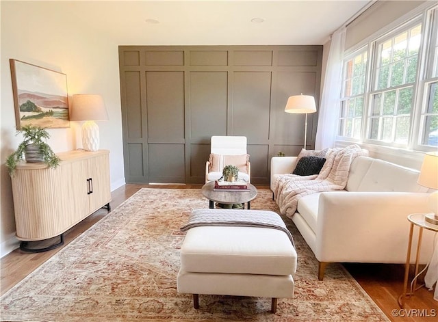living area featuring baseboards and wood finished floors