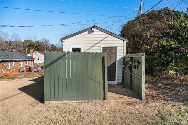 view of outdoor structure with fence and a gate