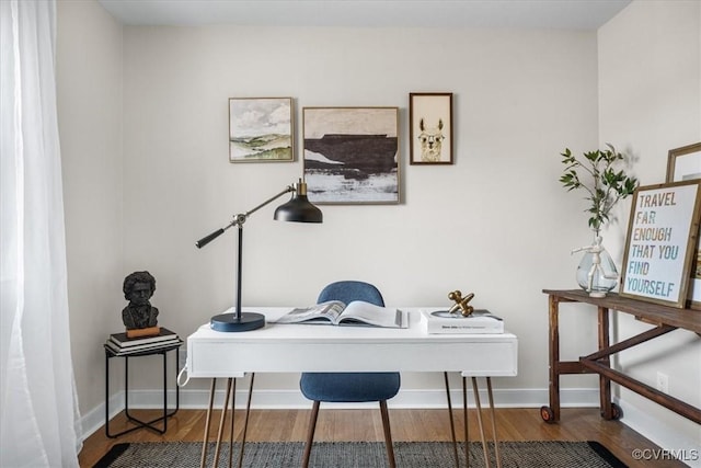 home office with baseboards and wood finished floors