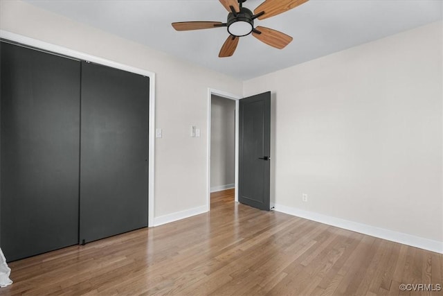 unfurnished bedroom with baseboards, a ceiling fan, and wood finished floors