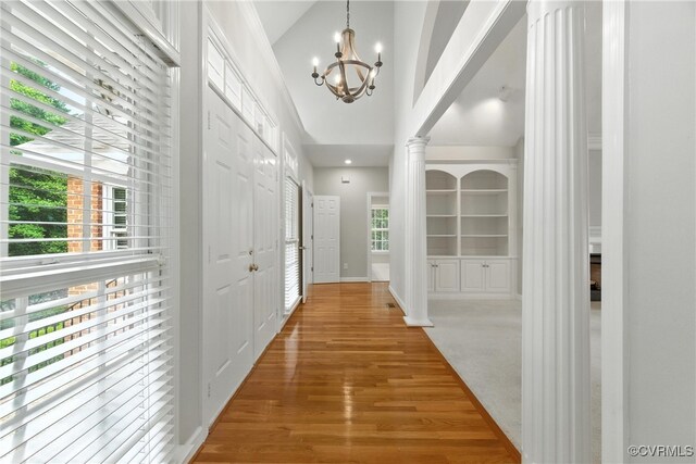 132 Warwick Hls, Williamsburg, VA 23188 - hallway featuring a chandelier, decorative columns, and wood finished floors