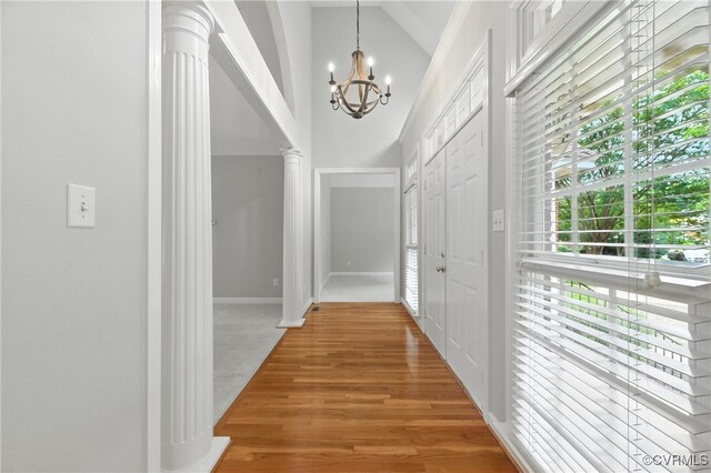 132 Warwick Hls, Williamsburg, VA 23188 - corridor with ornate columns, a chandelier, light wood-type flooring, and vaulted ceiling