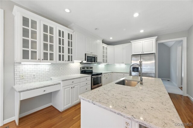 132 Warwick Hls, Williamsburg, VA 23188 - kitchen with stainless steel appliances, white cabinetry, glass insert cabinets, light wood-style flooring, and recessed lighting