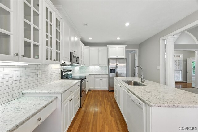 132 Warwick Hls, Williamsburg, VA 23188 - kitchen featuring stainless steel appliances, decorative columns, white cabinetry, tasteful backsplash, and light stone counters