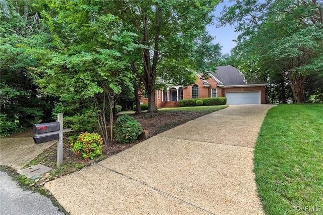 132 Warwick Hls, Williamsburg, VA 23188 - obstructed view of property featuring a garage, concrete driveway, brick siding, and a front yard