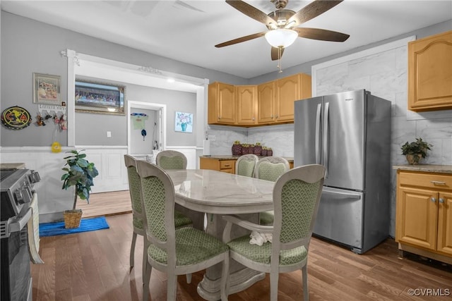 32390 S Main St, Boykins, VA 23827 - dining room featuring a ceiling fan, wood finished floors, and a wainscoted wall