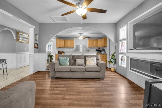 32390 S Main St, Boykins, VA 23827 - living area with wainscoting, ceiling fan, arched walkways, and wood finished floors
