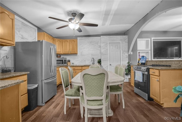 32390 S Main St, Boykins, VA 23827 - kitchen with ceiling fan, arched walkways, stainless steel appliances, and dark wood-type flooring