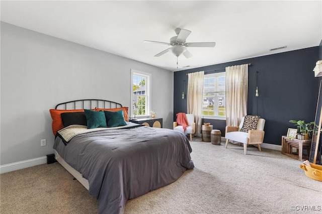 bedroom with visible vents, a ceiling fan, baseboards, and carpet