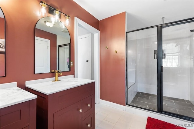 full bathroom featuring two vanities, a shower stall, tile patterned floors, and a sink
