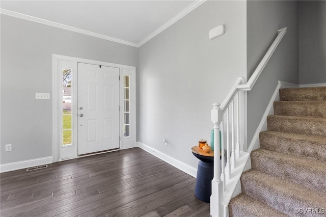 entrance foyer featuring stairway, dark wood finished floors, a wealth of natural light, and visible vents