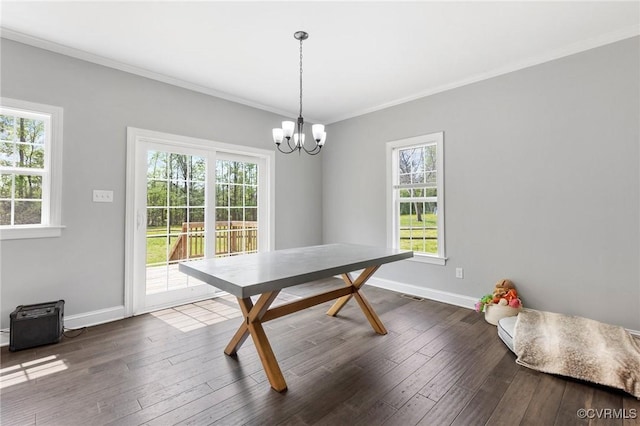 dining space with a wealth of natural light, crown molding, baseboards, and dark wood-style flooring
