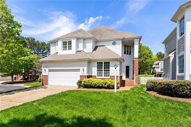 traditional home featuring a front lawn, driveway, a garage, and brick siding