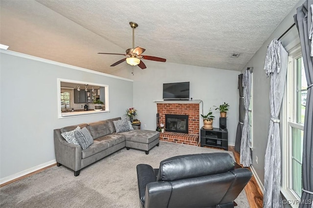 living room featuring a fireplace, ceiling fan, vaulted ceiling, and baseboards