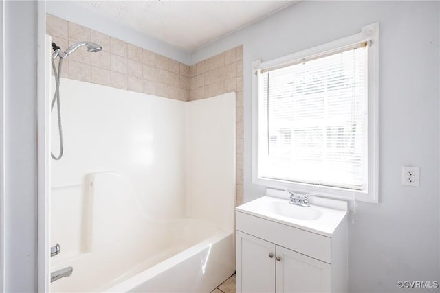 bathroom with shower / bathing tub combination and vanity