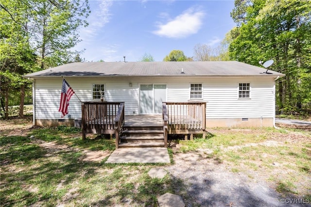 back of property featuring crawl space and a deck