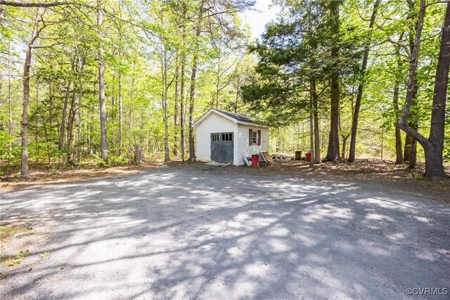 view of outbuilding featuring an outbuilding and a wooded view
