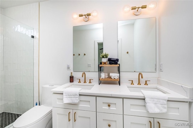 full bathroom with a stall shower, a sink, double vanity, and toilet