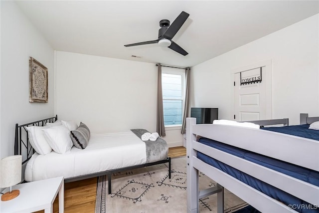 bedroom featuring a ceiling fan, visible vents, and light wood-style floors