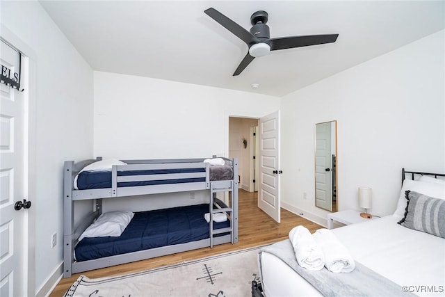 bedroom with baseboards, a ceiling fan, and wood finished floors