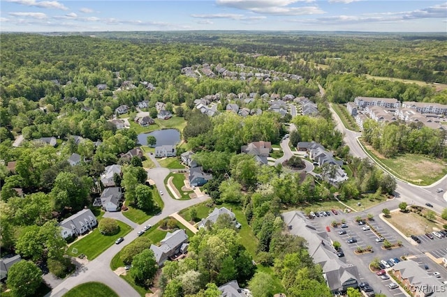 aerial view featuring a residential view, a water view, and a forest view