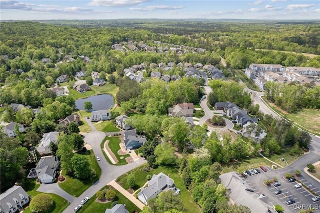 bird's eye view featuring a residential view, a water view, and a forest view