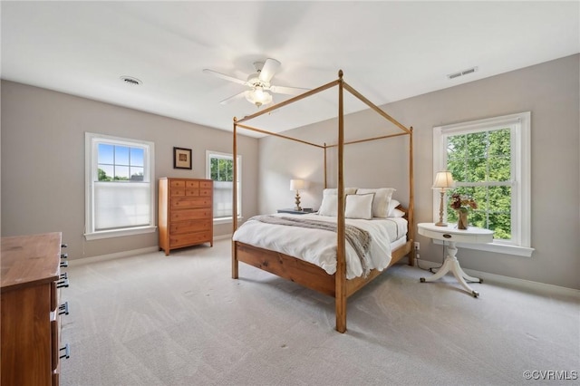 bedroom with light colored carpet, baseboards, and visible vents