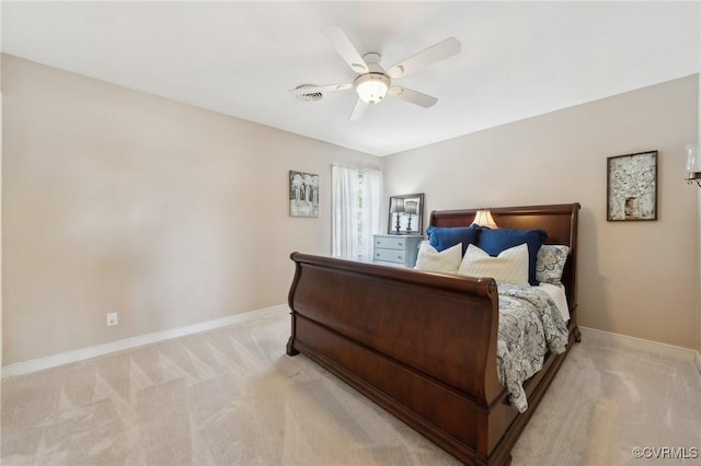 bedroom with a ceiling fan, baseboards, and light carpet