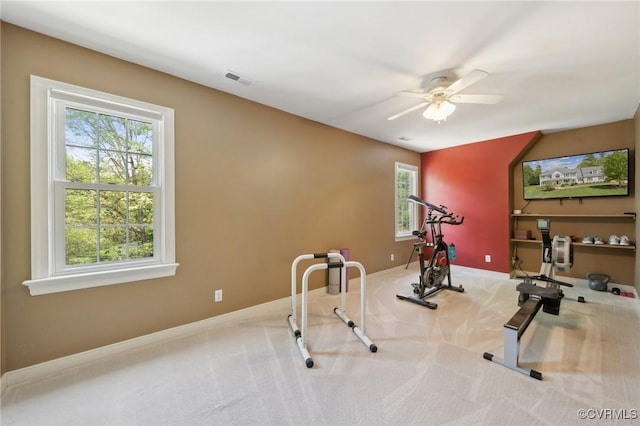 exercise room with baseboards, carpet, a ceiling fan, and visible vents