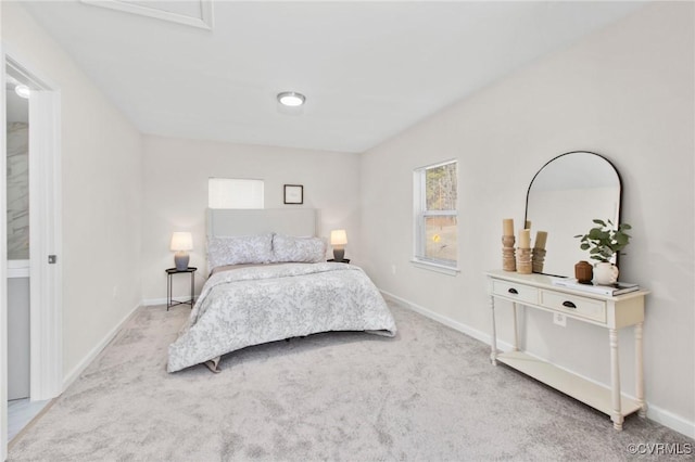 bedroom featuring baseboards and light carpet