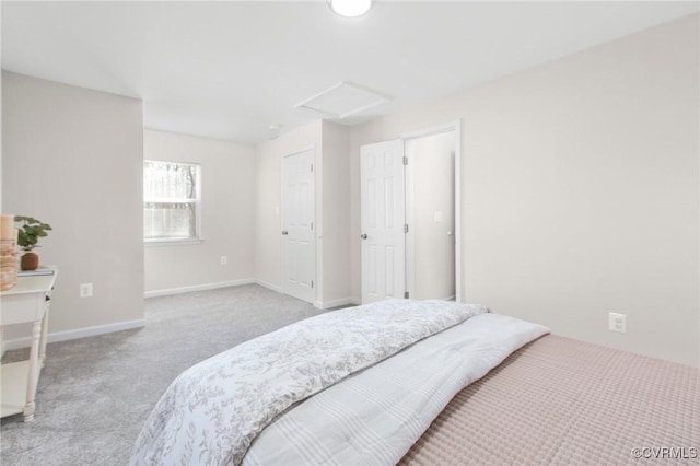 carpeted bedroom with baseboards and attic access