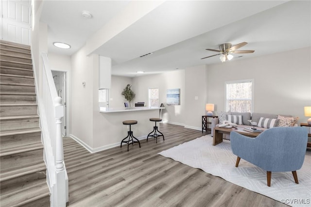 living room featuring baseboards, a ceiling fan, recessed lighting, wood finished floors, and stairs